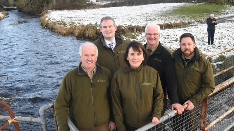 Minister Kyne (back, left) with IFI team