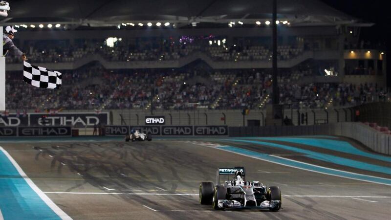 Mercedes Formula One driver Lewis Hamilton of Britain takes the chequered flag  to win  the Abu Dhabi F1 Grand Prix at the Yas Marina circuit. Photograph: Hamad I Mohammed / Reuters