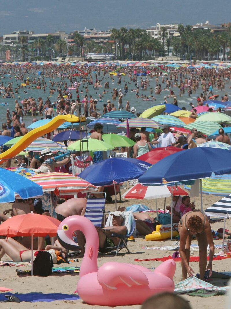 People enjoy the sun and the sea at Levante beach during their holidays in Salou, Catalonia, Spain. Photograph: Reuters