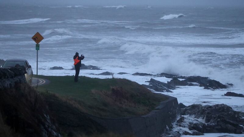 A man photographs waves caused by Storm Deirdre in Balbriggan, Co Dublin. Photograph: Niall Carson/PA Wire