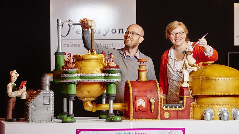 Christine and Phil Jenson of Peboryon with their Wallace and Gromit inspired cake that bakes a cake exhibit at Cake International