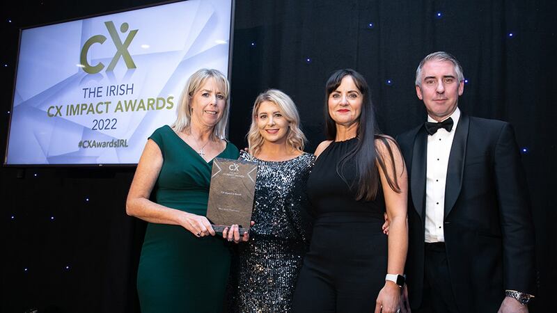 Paul Allen, awards judge, presents the CX Impact in Retail award to McCabes Pharmacy team.