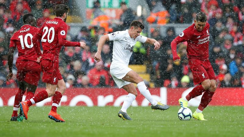 Burnley’s Ashley Westwood tackles Roberto Firmino. Photo: Andrew Yates/Reuters