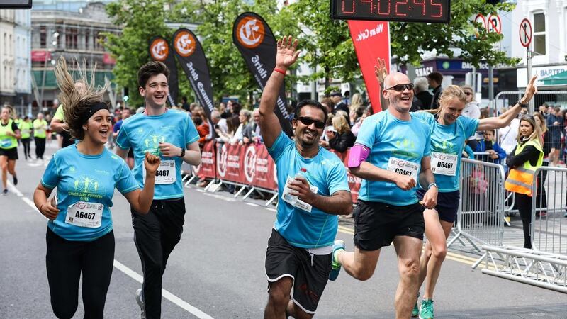 Muhammad Majid (centre) and his relay team of Jack, Fenella and John Riordan and Claire Lambe at the finish line of the Cork City Marathon 2019.