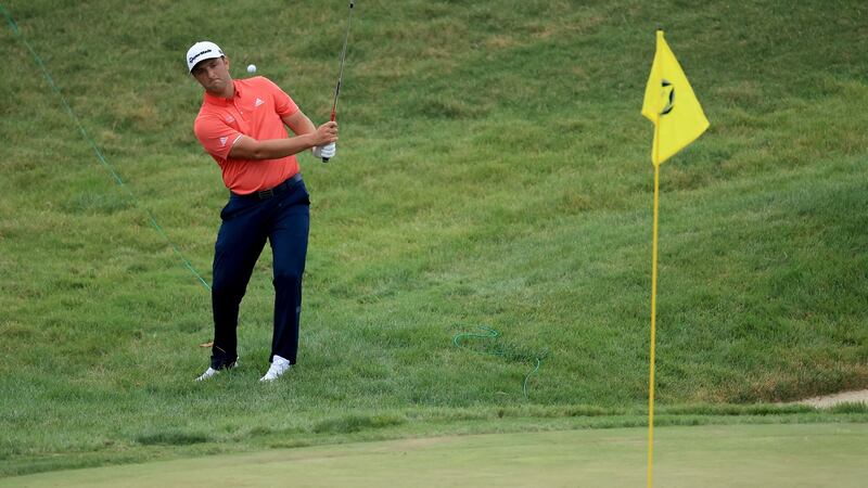 Rahm’s pitch in at the 16th for birdie was later changed to a bogey after he was given a two-stroke penalty because the ball moved. Photo: Andy Lyons/Getty Images