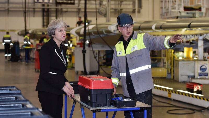 British prime minister Theresa May speaks to a worker during a visit to the Bombardier factory in Belfast before meeting the main political parties at Stormont, for talks aimed at ending the 13-month political stalemate. Photograph: Charles McQuillan/PA Wire