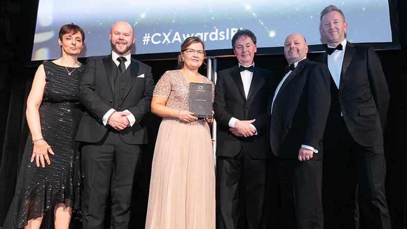 Gerard O'Neill, Awards Judge & Amárach Research presents the CX Impact in Retail award to the Eason team.