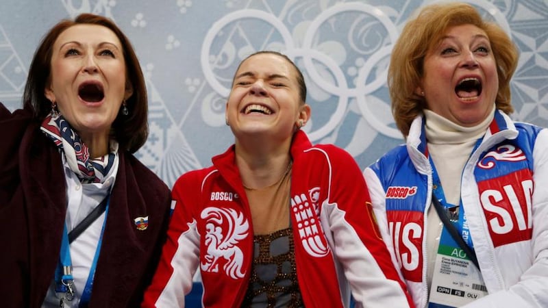 Russia’s Adelina Sotnikova (centre) reacts with her choreographer Irina Tagaeva (left) and her coach Elena Buyanova (right) ecstatic in the “kiss and cry” area after seeing her results   in the figure skating final at the Sochi 2014 Winter Olympics. Photograph:  Lucy Nicholson/Reuters