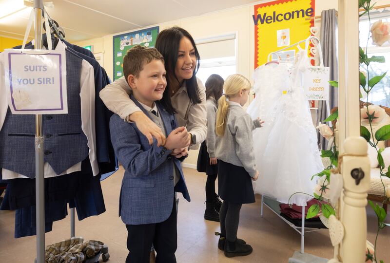 Fourth class pupil Paul Doherty and his mother Jacqueline at the Communion wear pop-up shop in Sacred Heart Primary School, Derry. Photograph: Joe Dunne