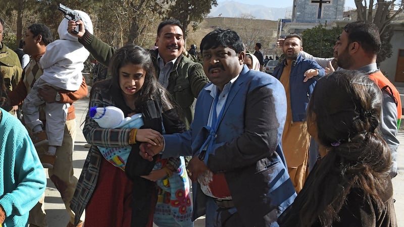 Pakistani Christians are evacuated by security personnel from a Methodist church after a suicide bomber attack during a Sunday service. Photograph: Banaras Khan/AFP/Getty Imag