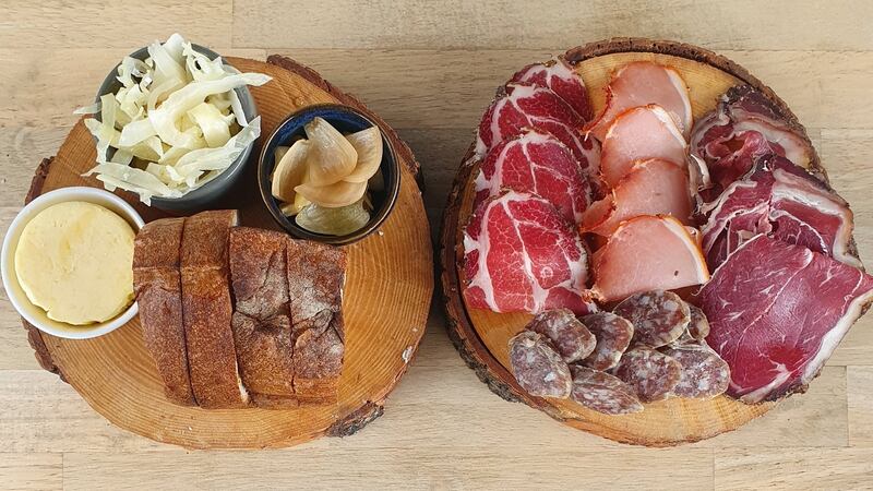 The charcuterie  has enough beef salami, lomo, coppa and air-dried lamb rump to feed four people as a snack. The second log is loaded with sourdough, butter and bowls of pickled cucumber and red cabbage