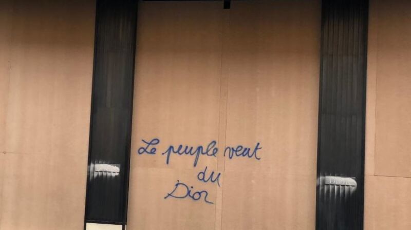 “The people want Dior,” stated graffiti scrawled on plywood covering the haute couture boutique’s windows. Photograph: Garret FitzGerald