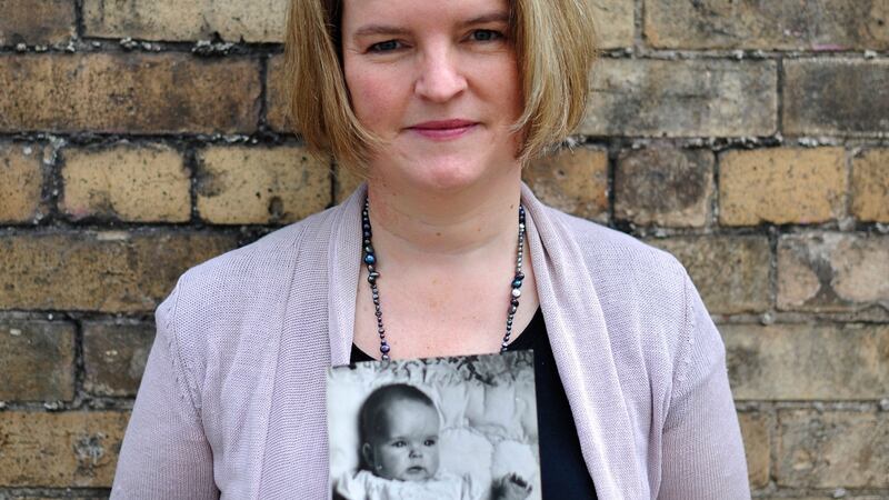 Eileen Heron  holds a picture of herself as a baby. Photograph: Aidan Crawley