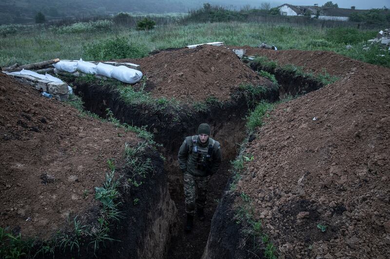 A Ukrainian soldier from the 95th Air Assault Brigade on sentry duty in a trench system along the front line near Izyum, Ukraine on May 27th. 