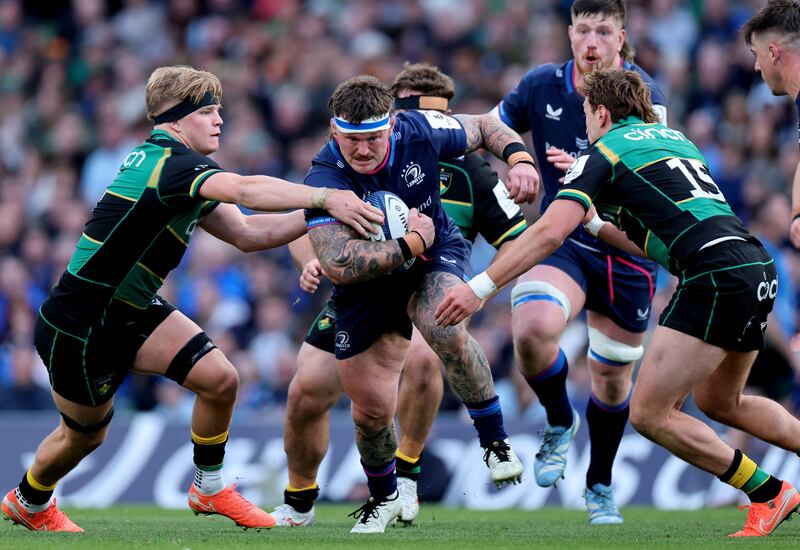 Leinster’s Andrew Porter is tackled by Northampton's Henry Pollock and James Ramm. Photograph: Billy Stickland/Inpho