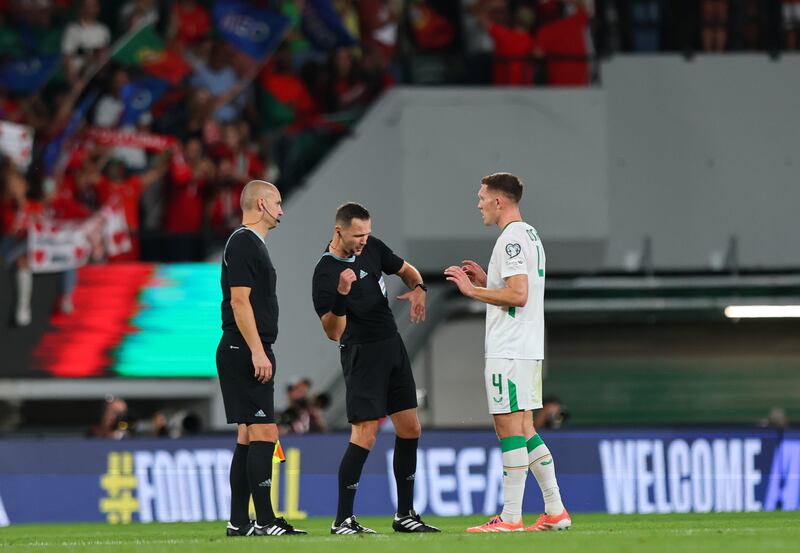 Ireland's Dara O'Shea speaks to referee Ivan Kružliak after Saturday's defeat to Portugal in Lisbon. Photograph: Ryan Byrne/Inpho