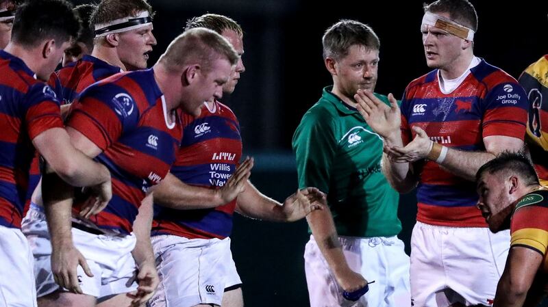 Michael Noone applauds his Clontarf team-mates after a scrum. Photograph: Tommy Dickson/Inpho