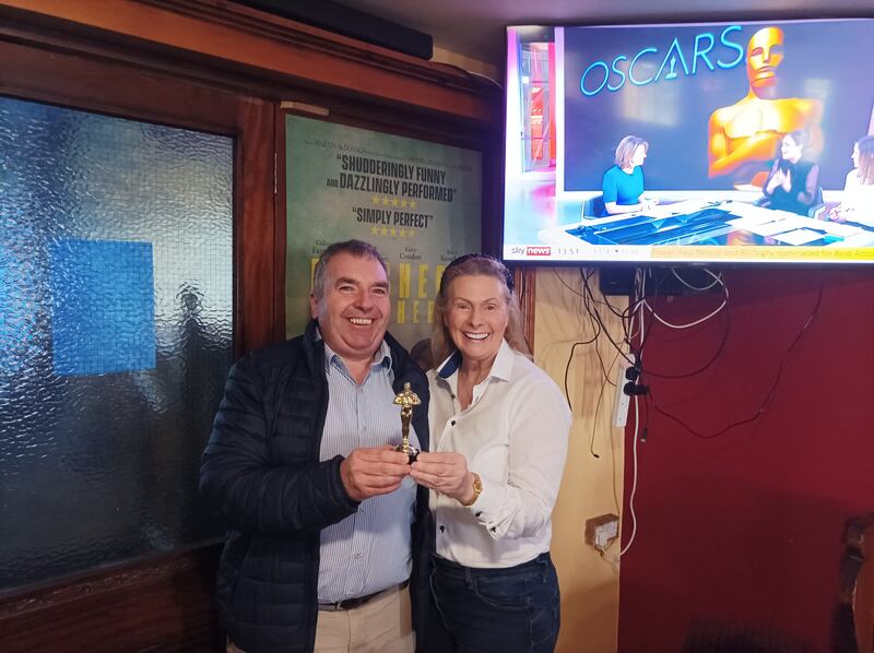 Chris McCarthy, manager of Achill Tourism, receives an impromptu Oscar statuette from Jackie Memory of McLoughlin’s Bar after The Banshees of Inisherin was nominated for nine Oscars. Photograph: Edwin McGreal