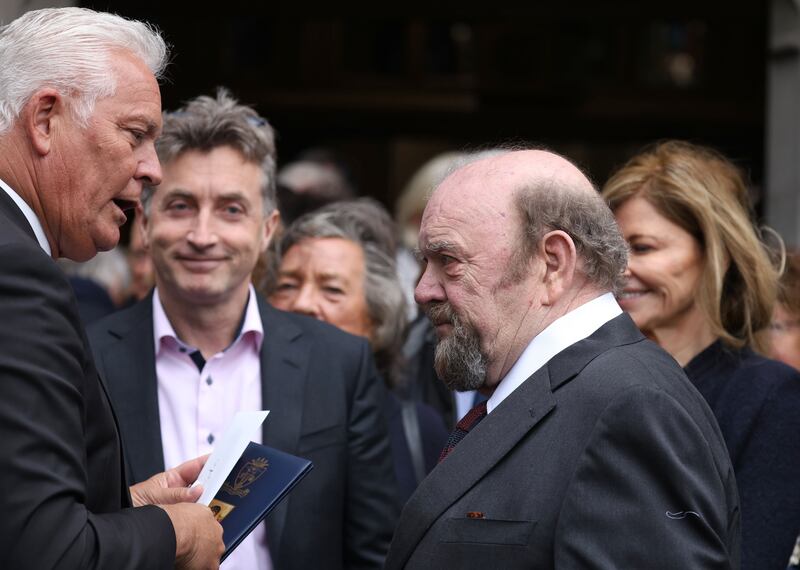 Former U2 manager Paul McGuinness (right) consoles Gavin O'Reilly at the funeral of his father, Tony. Photograph: Colin Keegan/Collins
