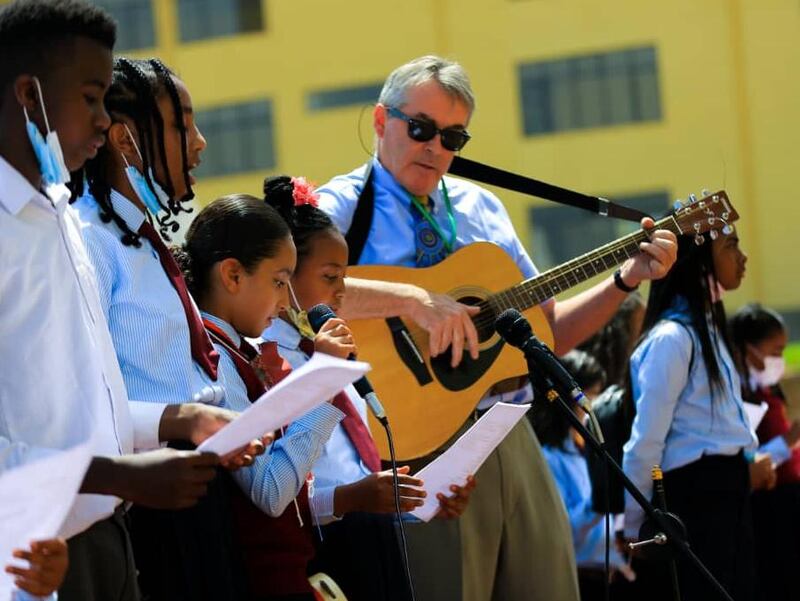 Cambridge Academy: John Kelleher is accompanied by middle-school pupils during a performance for the school’s family day