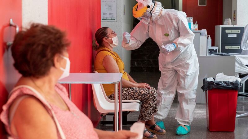 A health worker collects a swab sample from a woman at a clinic in Murcia, southeastern Spain on September 8th. Photograph: Marcial Guillan