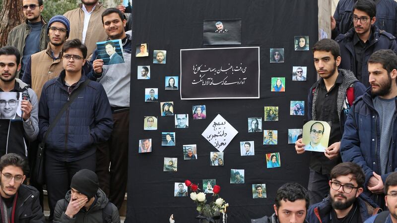 Students hold pictures of victims of last week’s plane crash in Iran at the University of Tehran on Tuesday. Photograph: Atta Kenare/AFP via Getty Images