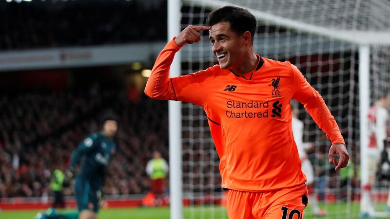 Philippe Coutinho points to his head after opening the scoring for Liverpool in the Premier League game against Arsenal at the Emirates Stadium. Photograph:  Eddie Keogh/Reuters
