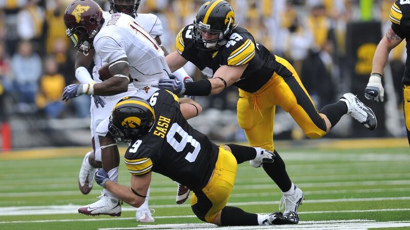 Tyler Sash is knocked back while playing for Iowa Hawkeyes against Minnesota Golden Gophers in 2009. Photo: David Purdy/Getty Images