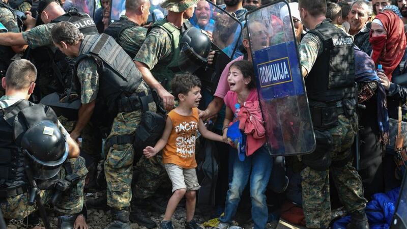 Macedonian police clash with migrants attempting to cross into the country after being stranded in no-man’s land overnight. Photograph: Georgi Licovski/EPA