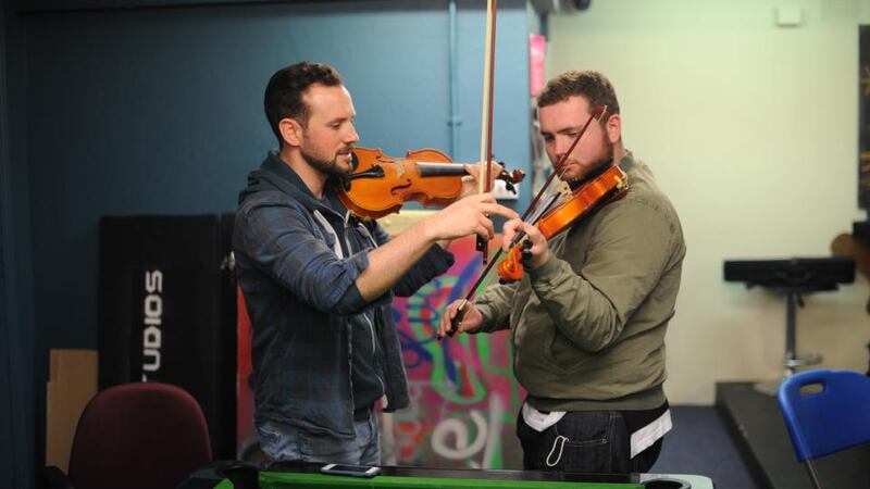 Eoghan Cleary (left) teaches Daniel O’Connor the violin in the music group in The Swan Youth Services in Ballybough, Dublin. Photograph: Aidan Crawley