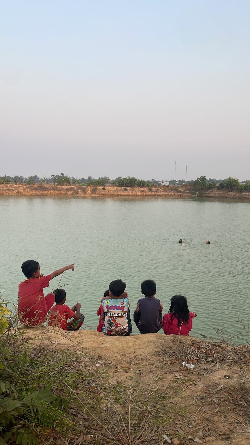 Volunteers swimming with local children at the village lake