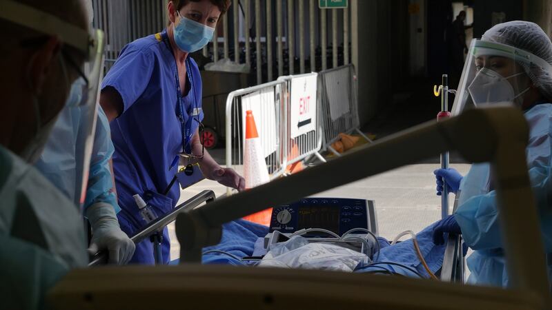 A patient is wheeled into St James Hospital by staff on Inside Ireland’s Covid Battle