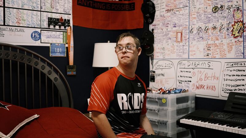 Chris Nikic with his “dream wall” in his bedroom in Maitland, Florida. Photograph: Zack Wittman