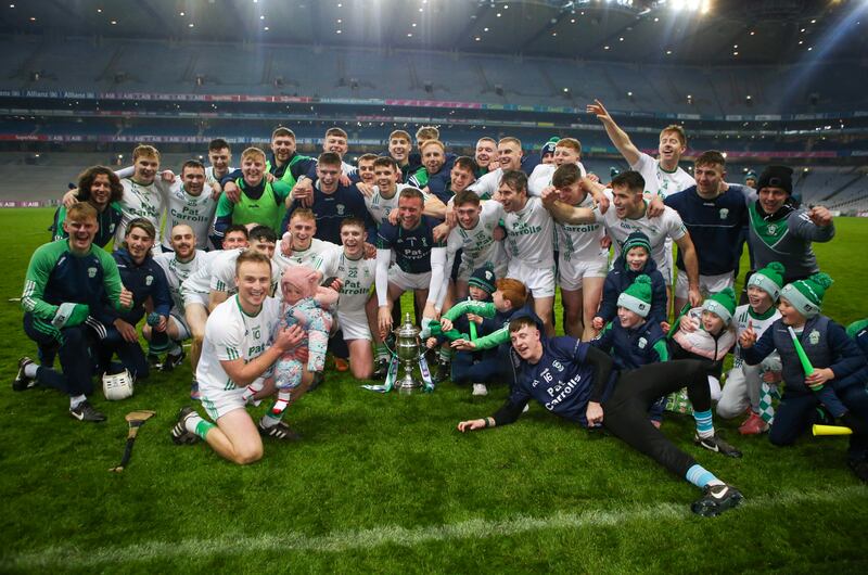 O’Loughlin Gaels players celebrate with the O’Neill Cup. Photograph: Ken Sutton/Inpho