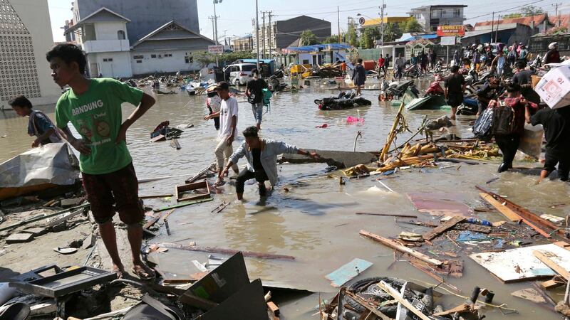 People surveying  the damage to a shopping mall following an earthquake and a tsunami in Palu, Central Sulawesi, Indonesia. Photograph: Tatan Syuflana/AP