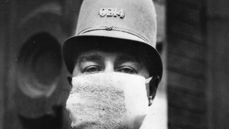 An American policeman wearing a flu mask in 1918 to protect himself from Spanish flu:  we are all looking for our own comforting Mixture. Photograph: Topical Press Agency/Getty
