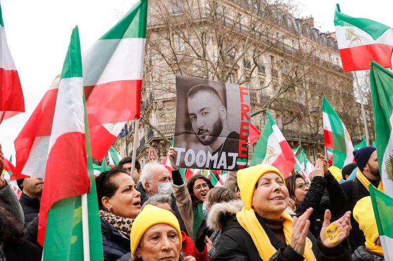 A woman holds a portrait of Iranian hip hop artist Toomaj Saleh during a demonstration in Paris, France, in February 2023. Photograph: Teresa Suarez