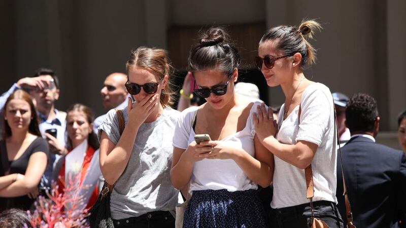 Mourners at Martin Place in Sydney on Tuesday where  siege gunman Man Haron Monis, was shot dead by police. Two other people died, 33-year-old cafe manager Tori Johnson and 38-year-old Sydney barrister Katrina Dawson. Six people have been injured and have been taken to hospital. Photograph: Getty