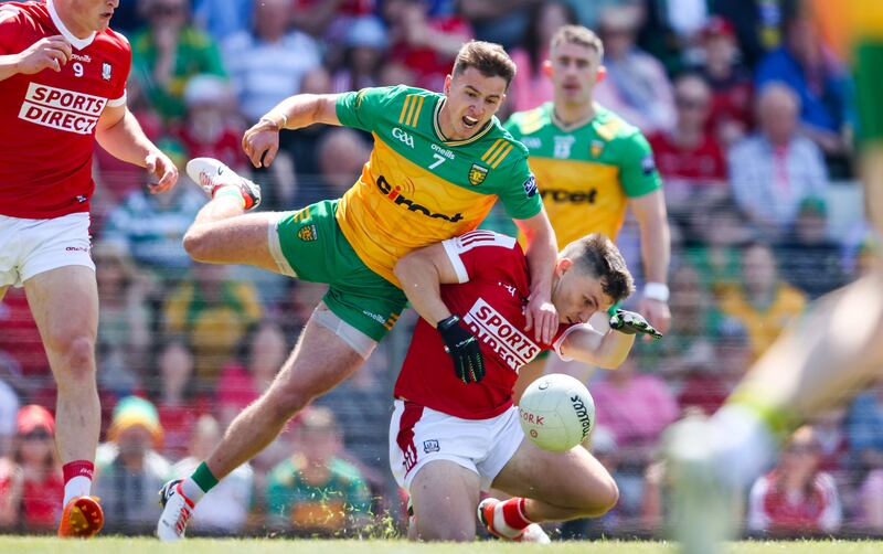 Donegal's Peadar Mogan is tackled by Cork's Sean Power during the game at Páirc Uí Rinn. Photograph: Nick Elliott/Inpho 