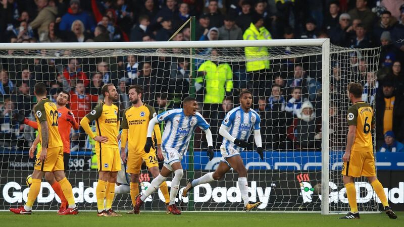 Steve Mounie wheels away after scoring Huddersfield’s opener against Brighton. Photograph: Mike Egerton/PA