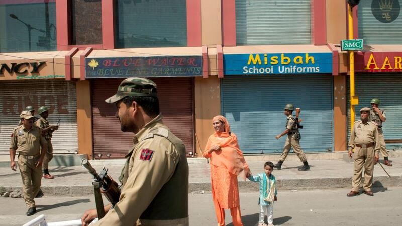 Indian security forces stand guard and shops are shuttered after a call for a strike to protest a performance by conductor Zubin Mehta in Indian-administered Srinagar, Kashmir, yesterday. Mehta’s performance was met with widespread criticism, as many Kashmiris complained that the public would not be admitted to the event. Photograph: Manpreet Romana/New York Times