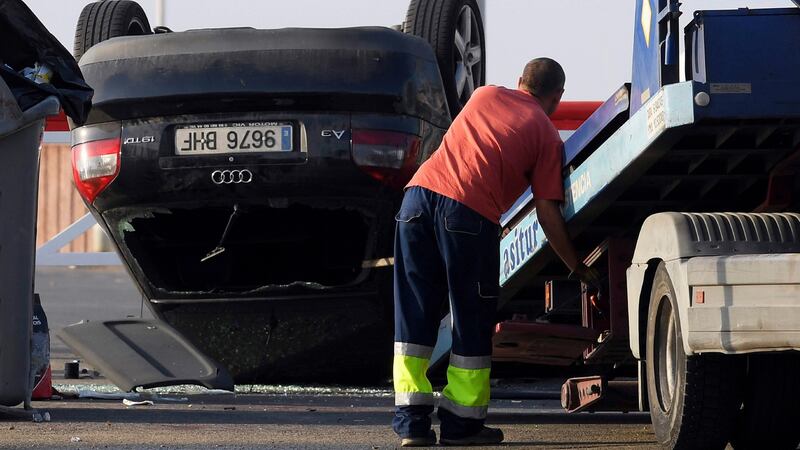 An employee starts to tow away a car involved in a terrorist attack in Cambrils, 120km south of Barcelona, on Friday morning. Photograph:  Luis Gene/AFP/Getty Images