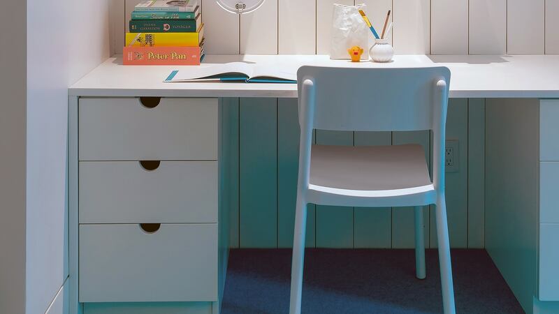 Ghislaine Vinas, an interior designer, created two study spaces for twins, separated by a wall with mailboxes that serve as storage shelves and pass-throughs. Photograph: Jaime Vinas