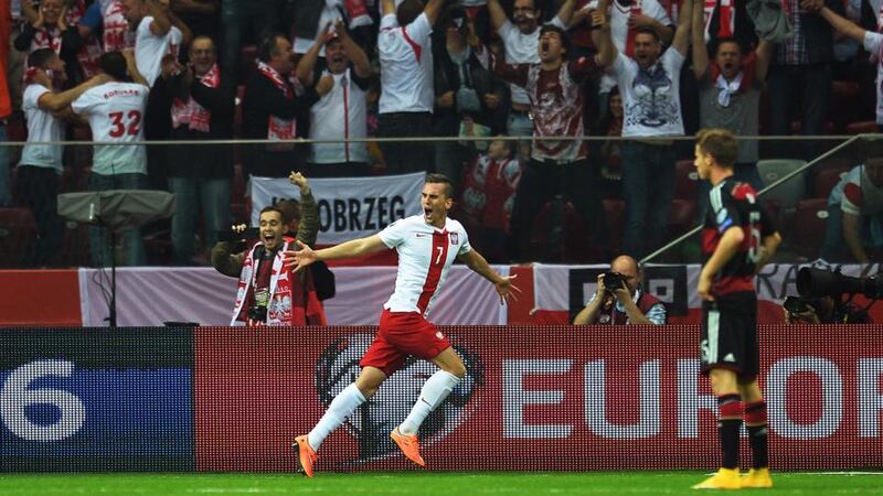 Poland’s   Arkadiusz Milik  celebrates after scoring  against Germany during the  qualifying campaign.