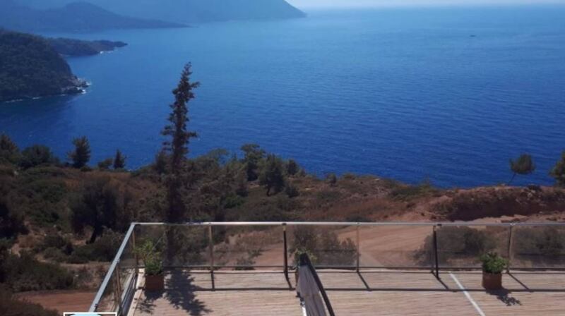 This  house in Turkey has floor-to-ceiling windows to make the most of the sea and mountain views.