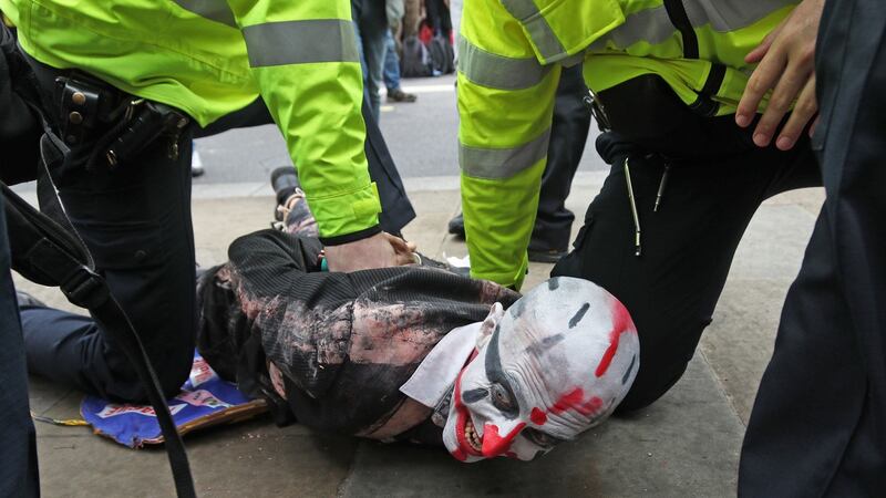 Police hold a protester during an Extinction Rebellion (XR) demonstration in Westminster, London.  Photo: Yui Mok/PA Wire