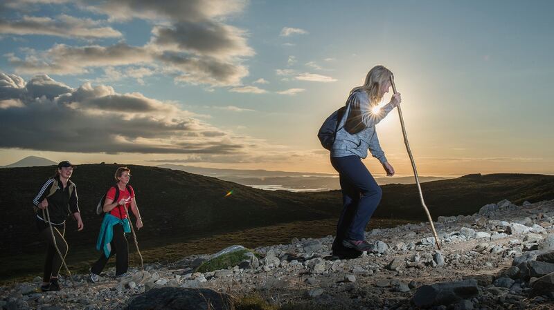 Pilgrims make their way up the rugged slopes of Croagh Patrick at sunrise. Photograph: Michael McLaughlin