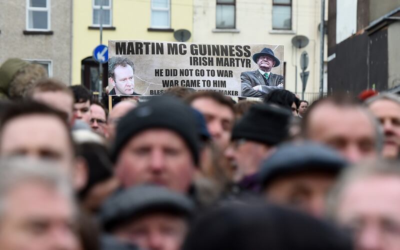 Mourners hold a banner for the late Martin McGuinness as they make their way to the funeral.  Photograph: Charles McQuillan/Getty Images