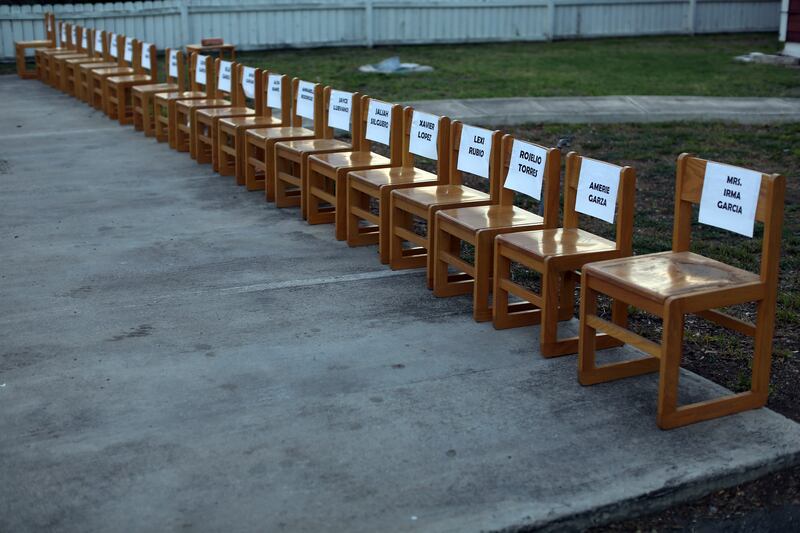 Twenty-one empty chairs are seen outside of a daycare centre as a memorial for the victims. Photograph: AP