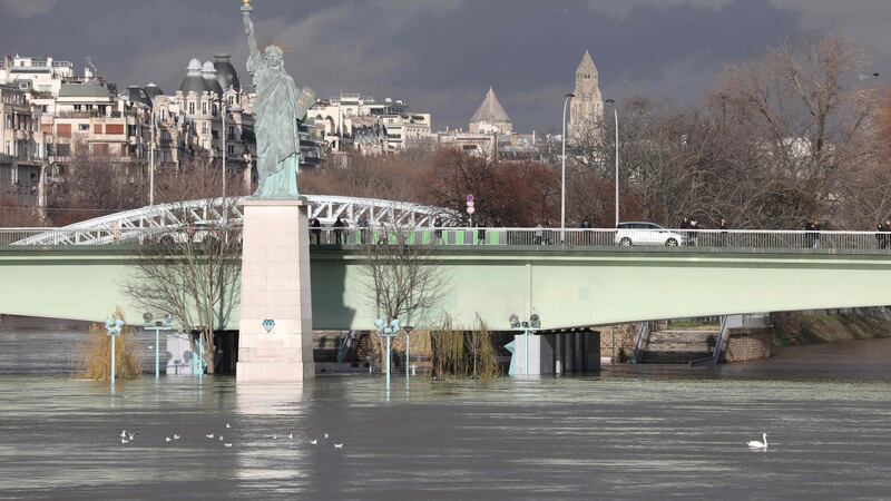 A picture taken on January 26, 2018, shows the flooded Ile aux Cygnes and banks of the river Seine with a model of the Statue of Liberty in Paris. Photograph: Getty